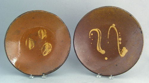 Appraisal: Two Pennsylvania redware plates th c with yellow slip decoration