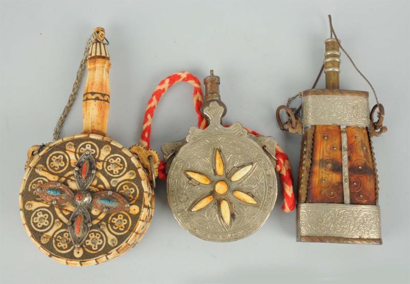 Appraisal: Lot of Bone Decorated Powder Flasks These three bone composed