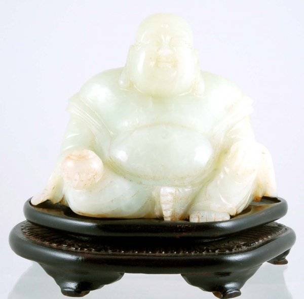 Appraisal: A Chinese carved celadon jade figure of Buddha seated and