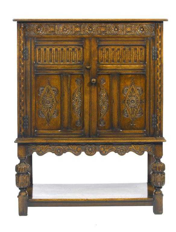 Appraisal: AN OAK LIVERY CUPBOARD BY G T RACKSTRAW LTD in