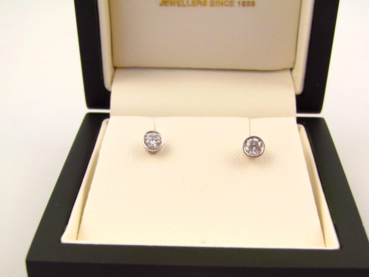 Appraisal: A pair of diamond set solitaire ear studs on plain