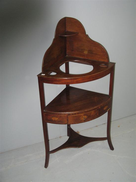 Appraisal: th century mahogany corner wash stand with shaped back the