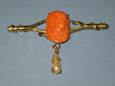 Appraisal: A CORAL AND PEARL BROOCH the rounded oblong coral panel