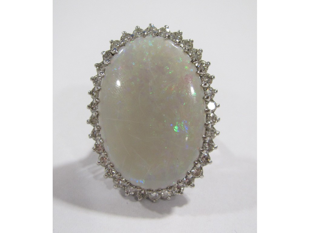 Appraisal: An eighteen carat white gold opal and diamond cluster ring