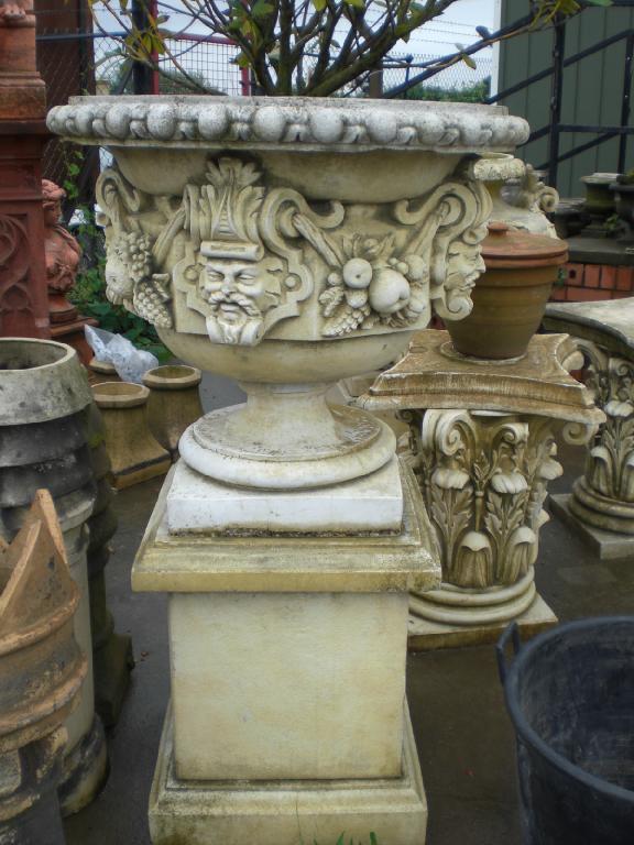 Appraisal: A large stone two handled Urn on pedestal base carved