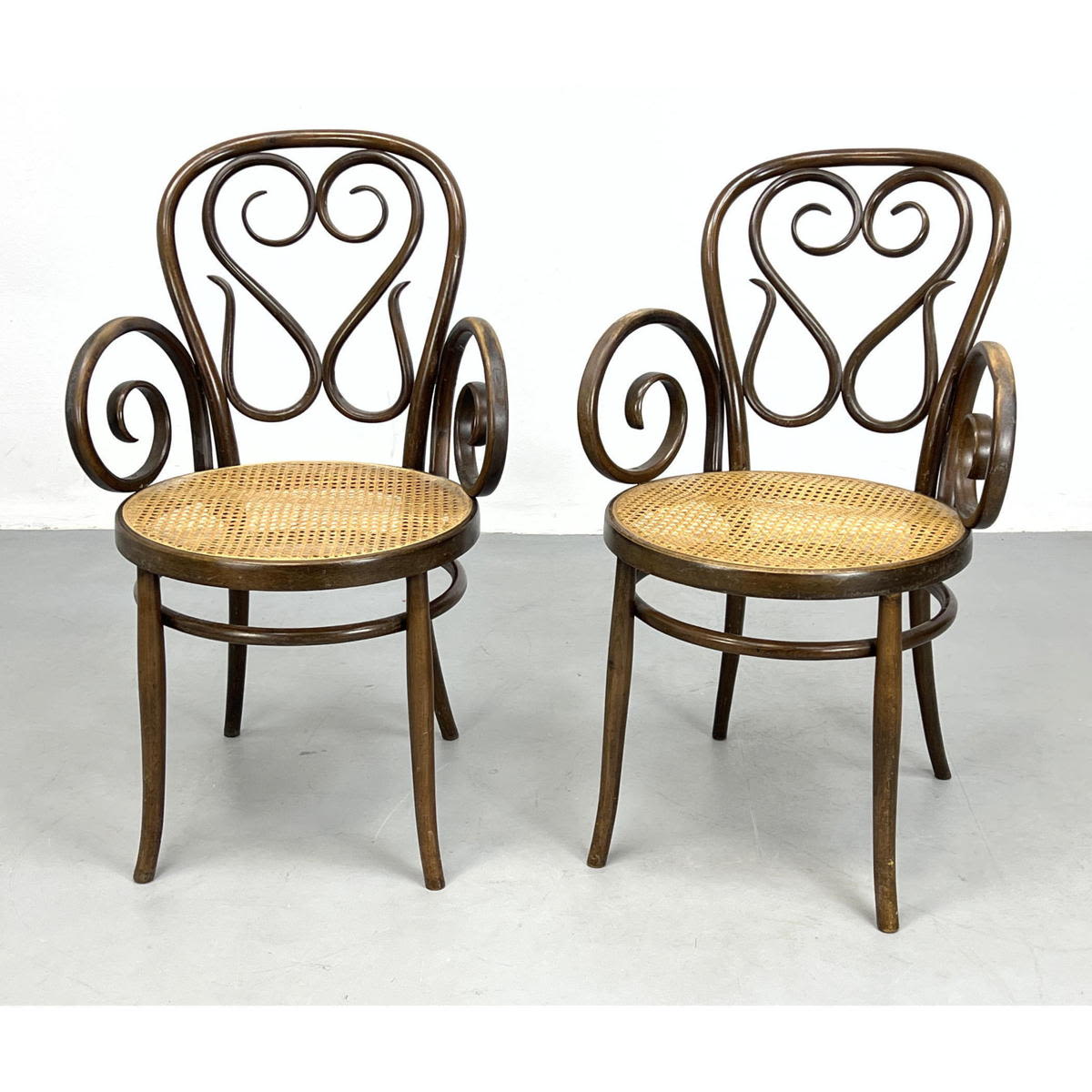 Appraisal: Pair Thonet Style Bentwood and Cane Arm Chairs Dimensions H