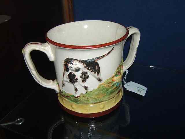 Appraisal: A STAFFORDSHIRE 'FROG MUG' TANKARD with two handles the exterior