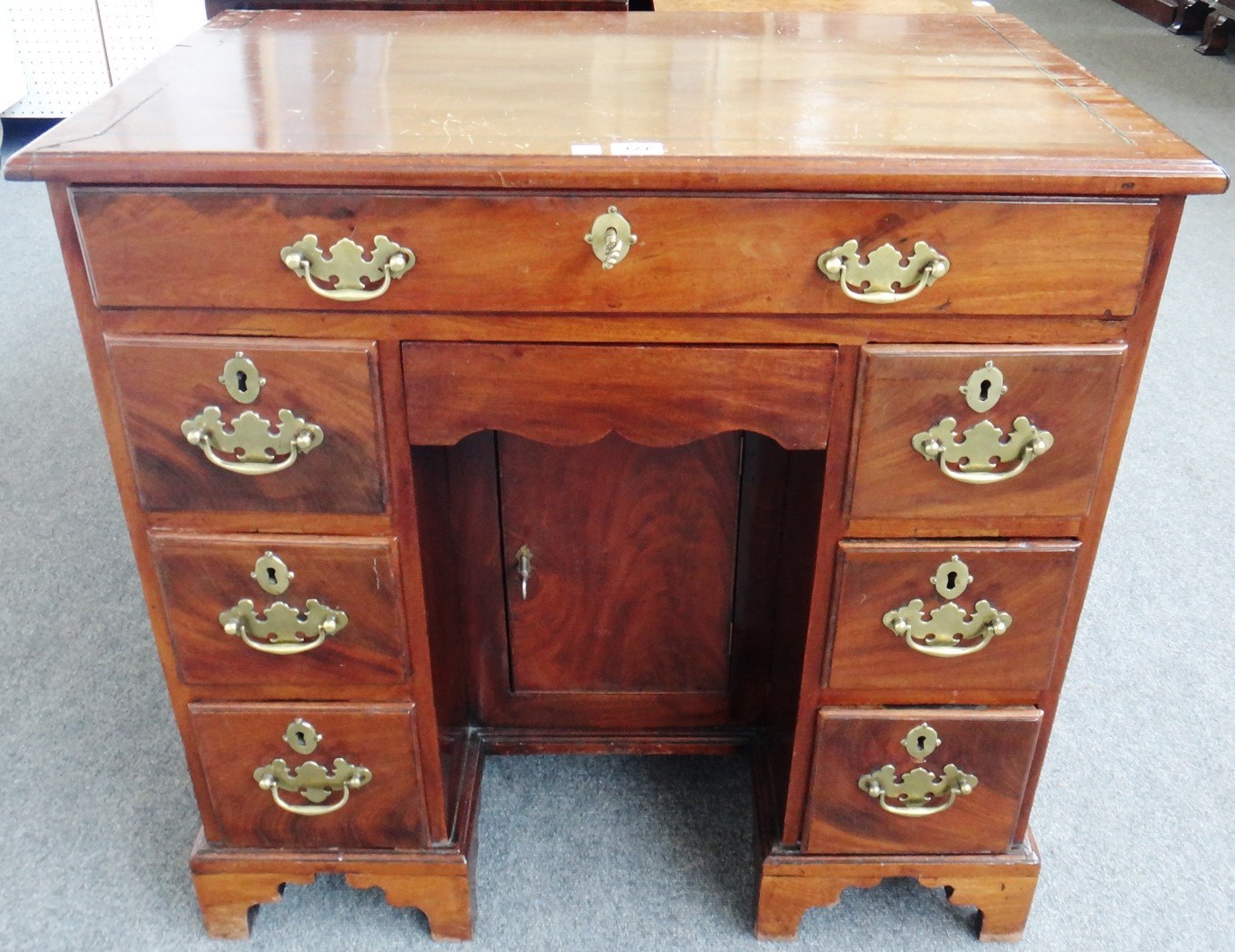 Appraisal: An th century mahogany knee hole writing desk with eight