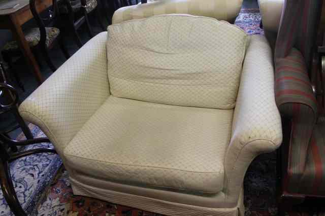 Appraisal: A LARGE MODERN ARMCHAIR with shaped arms and white upholstery