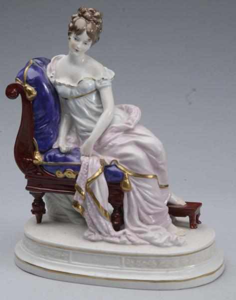 Appraisal: Sitzendorf Porcelain Figurine Description German china lady sitting on a