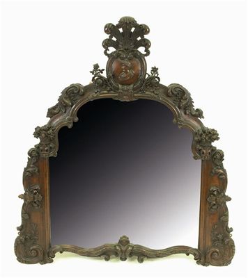 Appraisal: A th century French carved walnut overmantel mirror the shaped