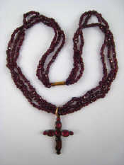 Appraisal: An antique three row garnet bead necklace with a garnet