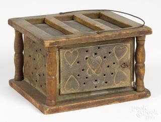 Appraisal: Punched tin footwarmer th c with heart decoration '' h