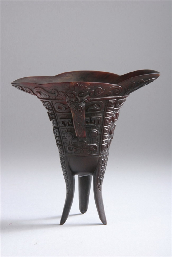 Appraisal: CHINESE RHINOCEROS HORN TRIPOD LIBATION CUP th- th century Quatrefoil