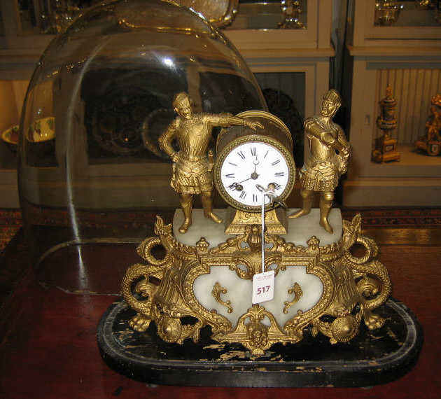 Appraisal: FRENCH SPELTER AND ONYX MANTLE CLOCK Two swordsmen flanking enamel