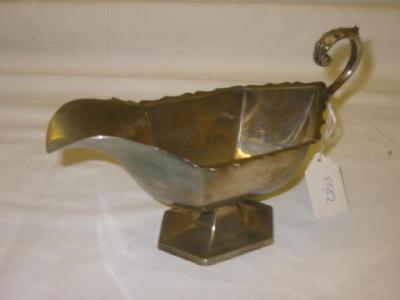 Appraisal: AN EDWARDIAN SAUCE BOAT of panelled oval form with gimped