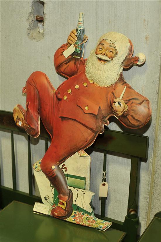 Appraisal: NORMAN ROCKWELL PEPSI SANTA Die cut cardboard dancing Santa holding