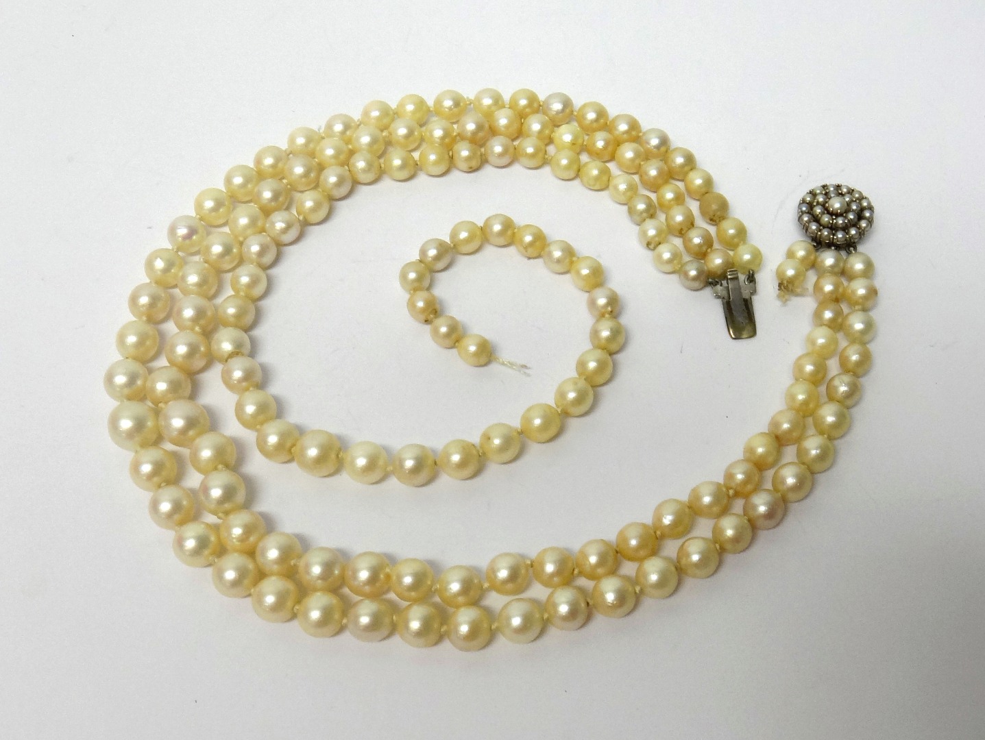 Appraisal: A three row necklace of cultured pearls graduating in size