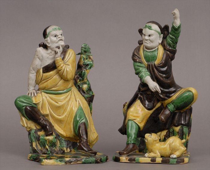 Appraisal: TWO CHINESE GLAZED BISCUIT FIGURES OF DEVILS Each seated the