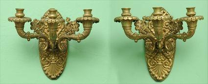 Appraisal: PAIR OF EMPIRE-STYLE GILT-BRASS THREE-LIGHT WALL SCONCES Each with oval