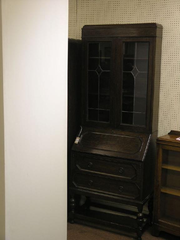 Appraisal: A solid dark oak bureau bookcase bookcase section enclosed by