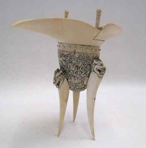 Appraisal: A CHINESE IVORY CARVED ''DEHUA JUE'' LIBATION CUP with shaped