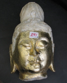 Appraisal: A CARVED MARBLE BUDDHA HEAD the face painted with gold