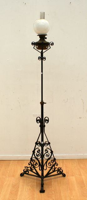 Appraisal: A French wrought iron standard lamp with adjustable column