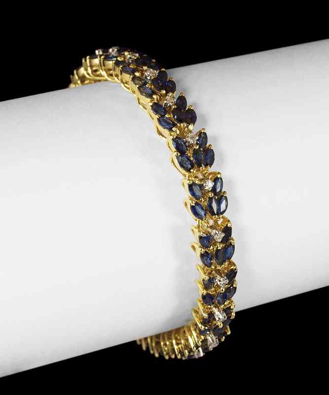 Appraisal: K SAPPHIRE AND DIAMOND BRACELET K yellow gold bracelet contains