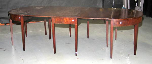 Appraisal: A George III style inlaid mahogany three part dining table