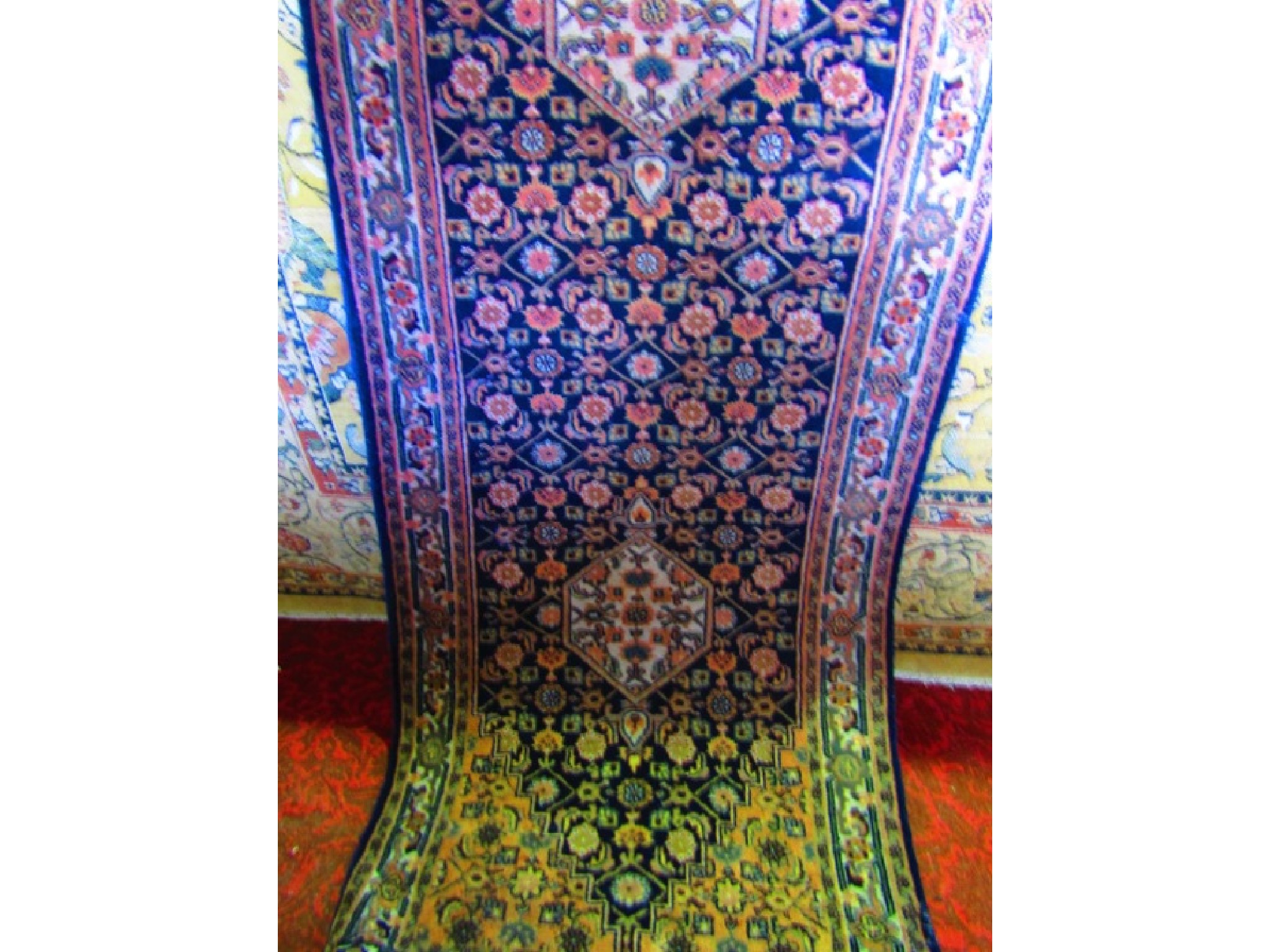 Appraisal: A wool runner with dark ground interspersed with symmetrical floral