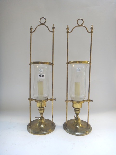 Appraisal: A pair of gilt metal hurricane lamps with Adams urn