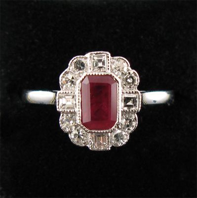 Appraisal: A ruby and diamond cluster ring the step cut ruby