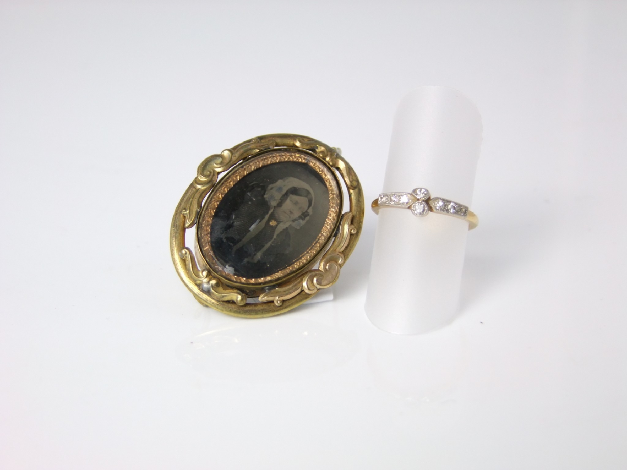 Appraisal: A gold diamond set ring together with a Victorian locket