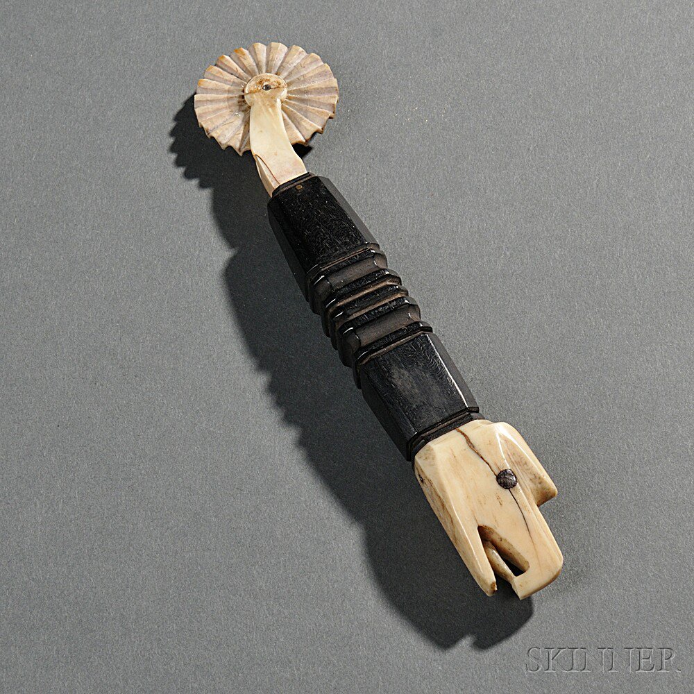 Appraisal: Carved Ivory and Ebony Eagle-head Jagging Wheel America th century