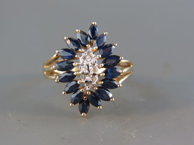 Appraisal: Sapphire and Diamond Ring rich blue marquise gems and round