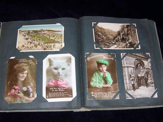 Appraisal: A postcard album including topographical views greeting cards Christmas cards