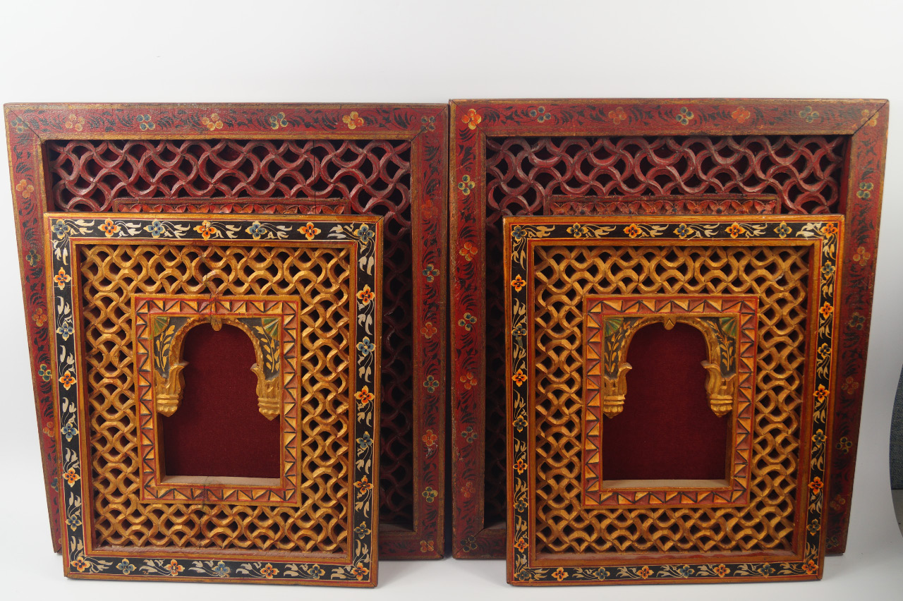 Appraisal: A pair of Indian carved and painted window panels with