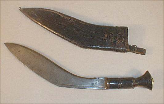 Appraisal: An Indian Kukri with a brass mounted horn handle and