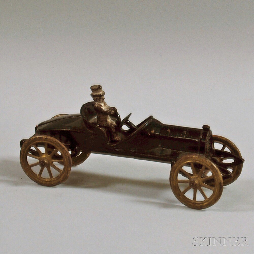 Appraisal: Small Black-painted Cast Iron Toy Car with Seated Metal Driver