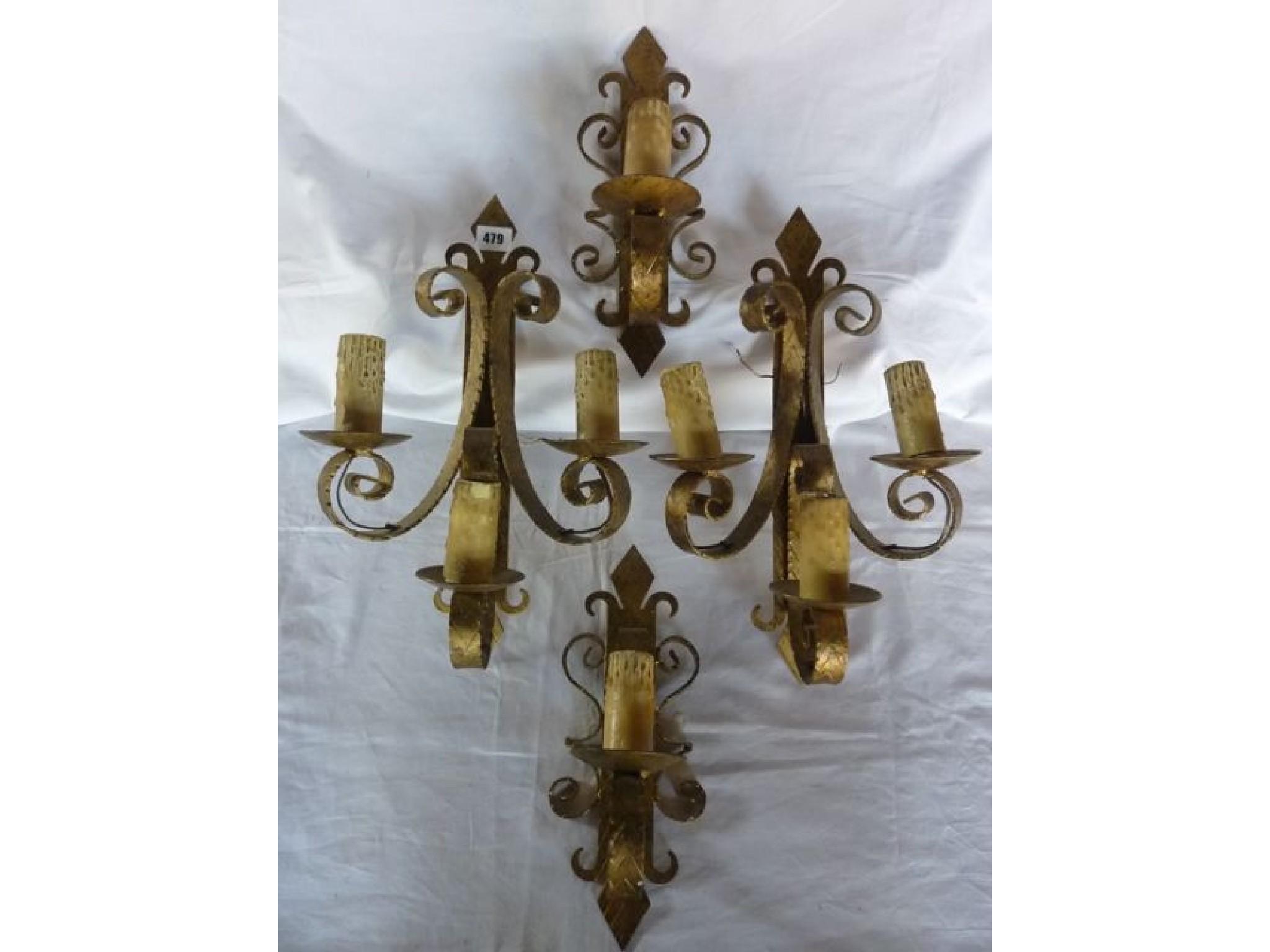 Appraisal: Four wrought iron wall lights two three branch two one