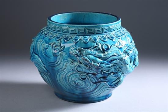 Appraisal: CHINESE TURQUOISE PORCELAIN CACHE-POT Qing Dynasty With dragon decoration in