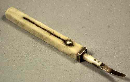 Appraisal: A Victorian gold coloured metal and ivory retractable tooth pick