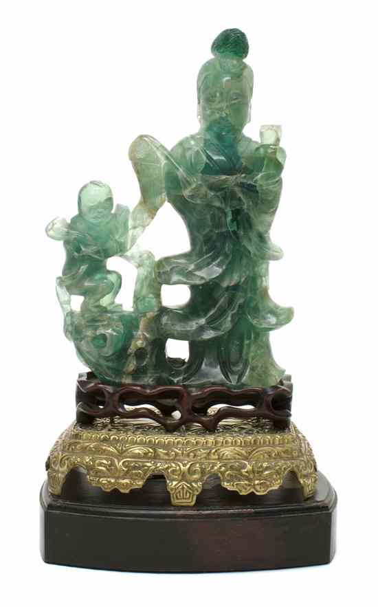 Appraisal: A Chinese Carved Hardstone Guanyin Figure the transparent green colored