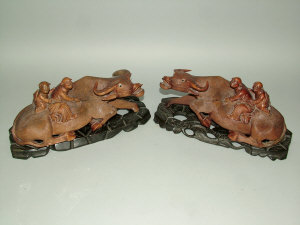 Appraisal: A pair of Chinese carved wooden groups of two children