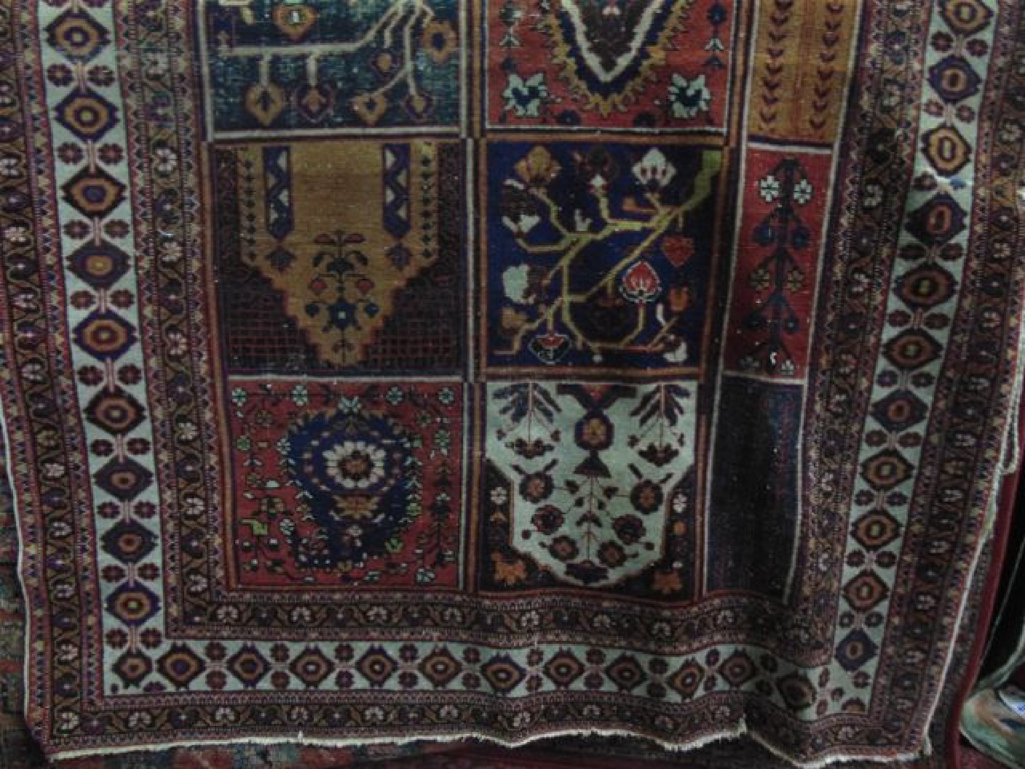 Appraisal: An old Persian rug the central field divided between ten