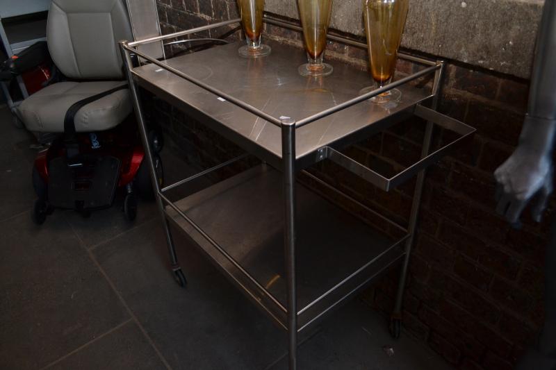 Appraisal: A TWO TIER STAINLESS STEEL AUTO TROLLEY A TWO TIER