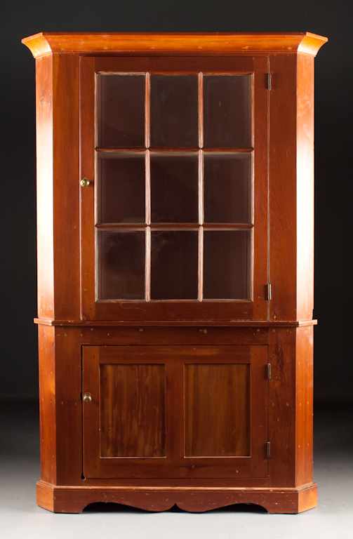 Appraisal: American vernacular pine and cherry glazed panel door china cupboard