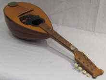 Appraisal: An eight string mandolin with Jim Dunlop plectrum