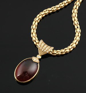 Appraisal: A garnet and diamond pendant necklace The pear shaped garnet